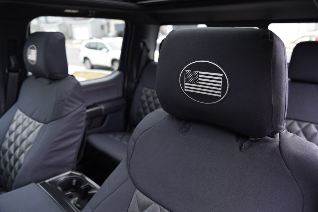 2021 Ford F-150 front headrest with Black Dura EZ-Care canvas cover and white American flag emblem, alongside Black Ostrich Diamond seat inserts