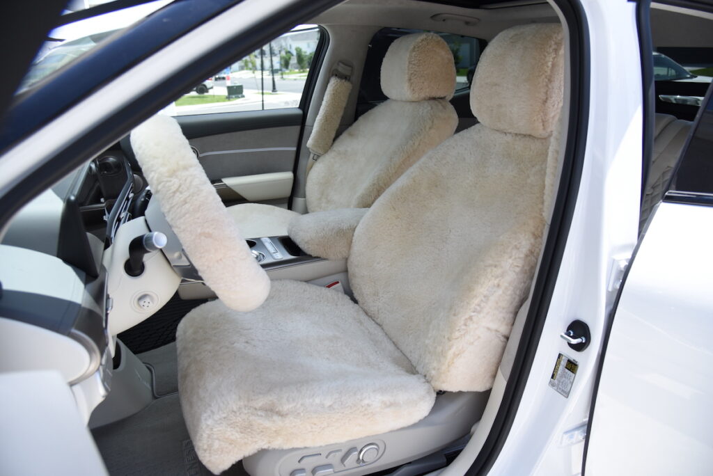 2023 Genesis GV60 front Sand (Pearl) sheepskin seat covers with matching sheepskin steering wheel cover