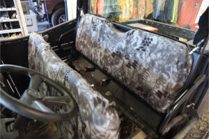 2015 Polaris Ranger front bench seat covered in Kryptek Raid camouflage canvas