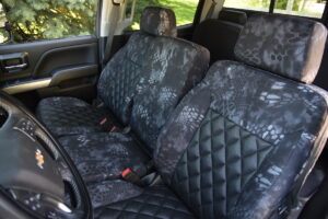 2019 Chevy Silverado 3500 front Kryptek Typhon seat covers with Black Ostrich Diamond inserts and center console cover