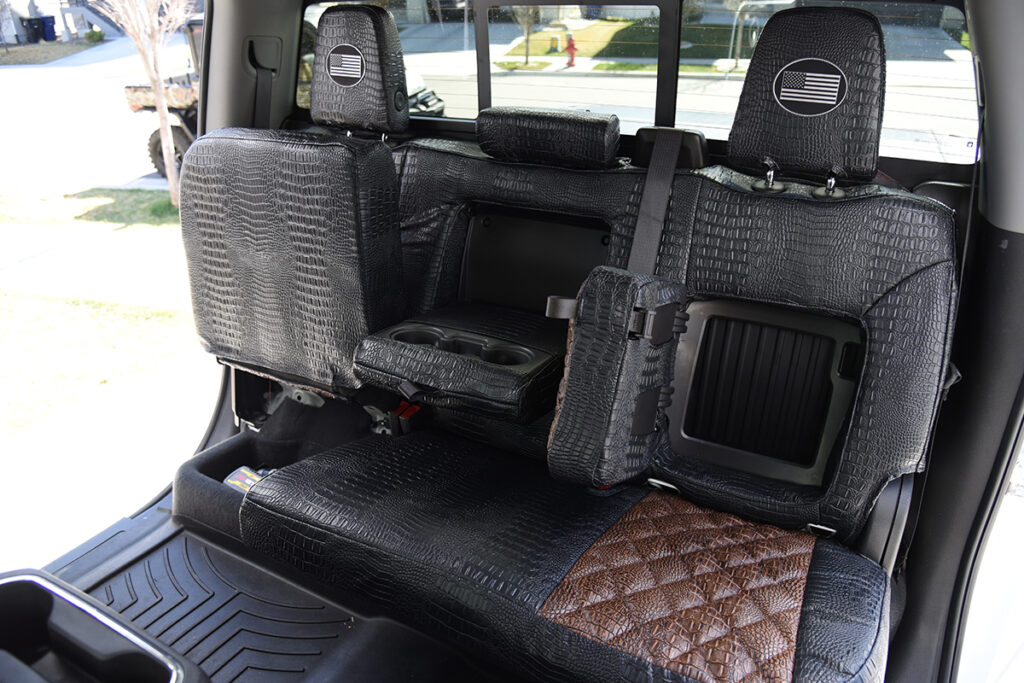 2024 GMC Sierra 3500 rear Alligator seat covers with open rear storage compartment and Midnight Croc trim