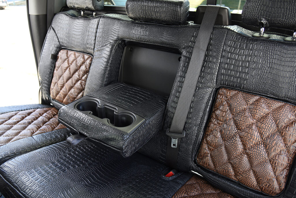 2024 GMC Sierra 3500 rear Alligator seat covers with fold-down armrest, Java Croc Diamond Stitch inserts, and Midnight Croc trim