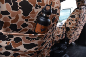 2018 Ford F-350 Duck Camo Bronze Series seat back pocket holding a black water bottle