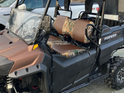 2022 Honda Pioneer passenger side view with Brown Ostrich and Realtree Xtra UTV seat covers