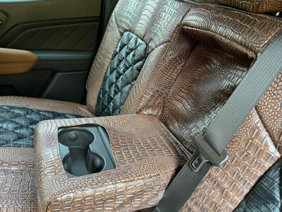 2024 GMC Canyon center console cover with Java Croc and Midnight Croc Diamond Alligator seat covers