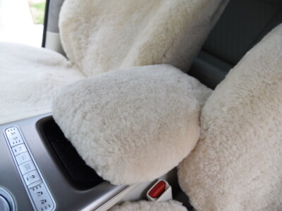 2023 Genesis GV60 front Sand (Pearl) sheepskin seat covers with matching sheepskin steering wheel cover