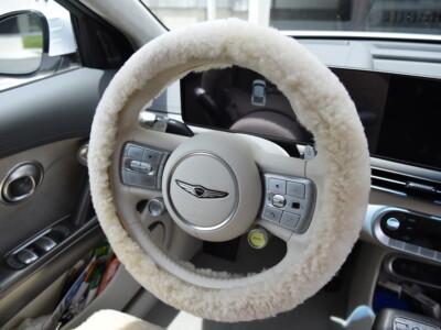 2023 Genesis GV60 front Sand (Pearl) sheepskin seat covers with matching sheepskin steering wheel cover