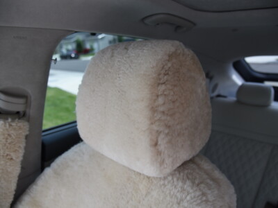 2023 Genesis GV60 front Sand (Pearl) sheepskin seat covers with matching sheepskin steering wheel cover