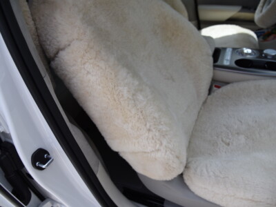 2023 Genesis GV60 front Sand (Pearl) sheepskin seat covers with matching sheepskin steering wheel cover