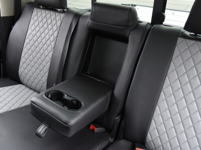 2022 RAM 1500 | Light Gray Diamond | Black Faux Leather 2022 RAM 1500 center armrest with Light Gray Diamond faux leather seats