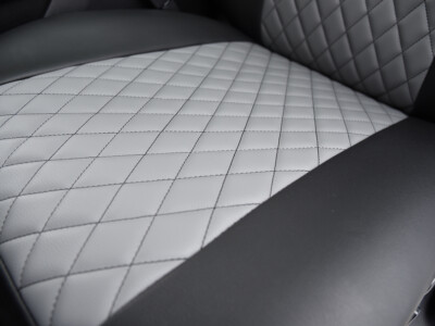 2022 RAM 1500 | Light Gray Diamond | Black Faux Leather Light Gray Diamond faux leather stitch detail inside a 2022 RAM 1500