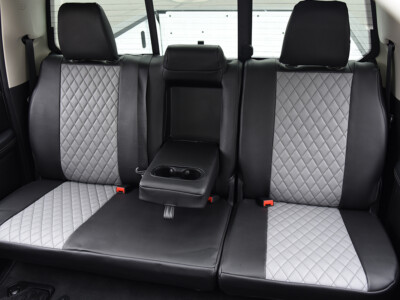 2022 RAM 1500 | Light Gray Diamond | Black Faux Leather 2022 RAM 1500 rear fold down armrest with Light Gray Diamond faux leather