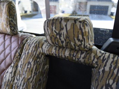 2026 Ford F-350 | Brown Ostrich Diamond Stitch | Mossy Oak Bottomland Headrest close-up of 2026 Ford F-350 seat covers in Brown Ostrich Diamond Stitch leatherette and Mossy Oak Bottomland camouflage