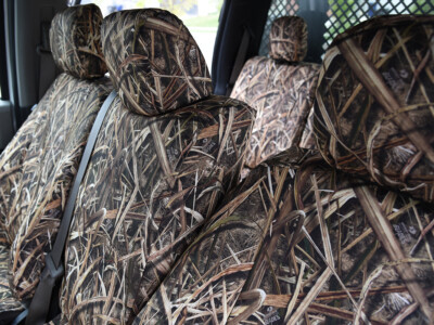 Front cabin angle of 2019 Ford F-550 seat covers in Mossy Oak Shadow Grass Blades camouflage
