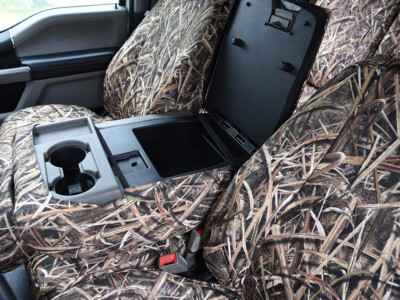 Closed console view of 2019 Ford F-550 seat covers in Mossy Oak Shadow Grass Blades camouflage