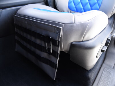 2023 Jeep Grand Cherokee armrest cover with side storage panel beside Blue Leatherette Diamond and Medium Gray Sof-Touch seat cover